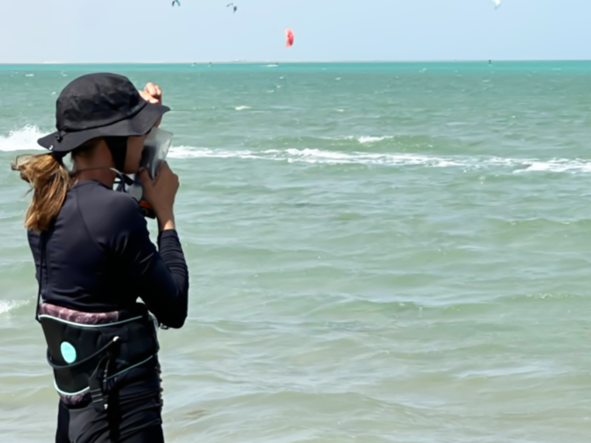 kitesurfing instructor teaching with walkie talkie